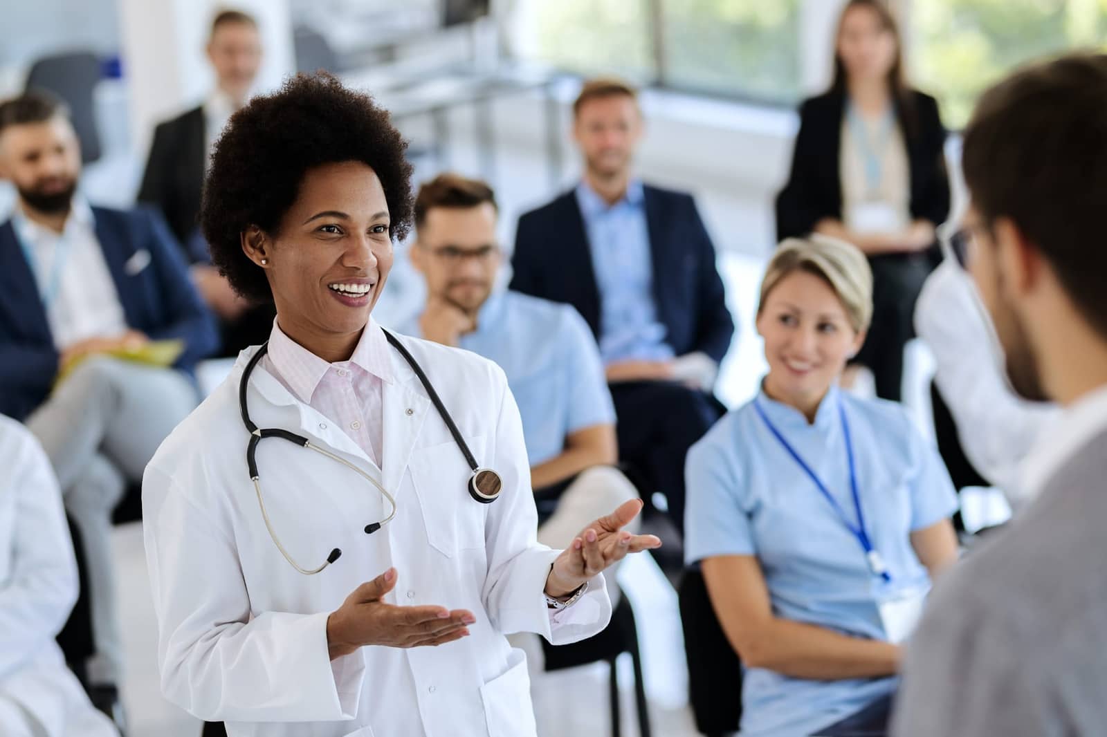A physician leading a continuing-education session for clinicians
